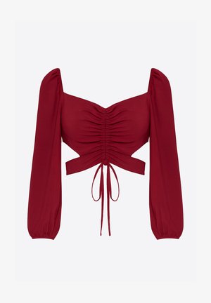 Rote, kurz geschnittene Bluse mit quadratischem Ausschnitt, gerafften Details vorne, langen Puffärmeln und einer Bindung an der Taille. Glatte Stoffstruktur.