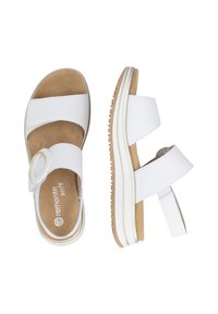 Sandales à plateforme blanches avec deux larges brides, une boucle circulaire sur la bride avant, une semelle intérieure beige et une semelle en caoutchouc texturée.