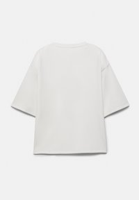 T-shirt blanc uni à manches courtes oversize avec épaules tombantes, col rond et coupe ample et carrée, vu de dos.