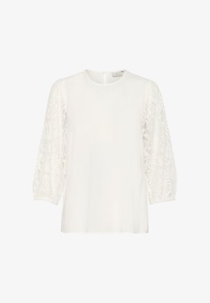 White blouse featuring sheer lace puff sleeves, round neckline, and keyhole back detail. Soft, lightweight fabric with delicate texture.