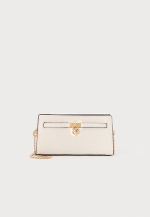 Light beige leather wallet with gold hardware, chain strap, and a flap closure. Features a smooth texture and black edging.