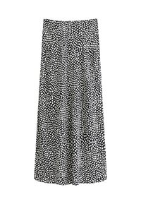 Jupe noire et blanche à motifs, de longueur genou, fabriquée dans un tissu lisse, avec un quadrillage de petites formes carrées irrégulières et un léger plissé.