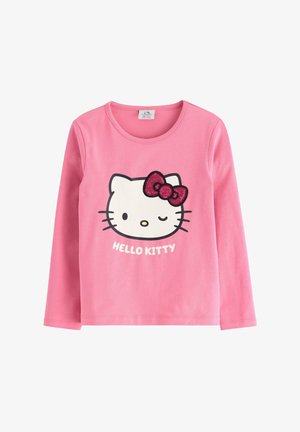 Langärmliges, pinkes Baumwollhemd mit einem Hello Kitty-Graphic, das eine Pailletten-Schleife zeigt, und dem Text "HELLO KITTY" darunter. Weiches, lässiges Design.
