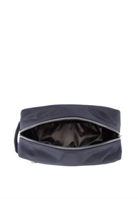 Mørkeblå stofpose med en glat overflade, lynlås og rummeligt indre. Har et håndtag på den ene side for nem transport.