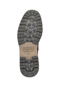 Bruine rubberen zool met textuurprofielen en een centraal logo. Kenmerkt zich door diepe groeven voor grip en verstevigde randen voor duurzaamheid.