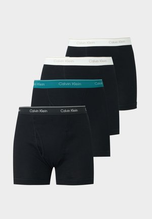 Four black Calvin Klein boxer briefs arranged overlapping, each with a different colored waistband—black, teal, and two white.