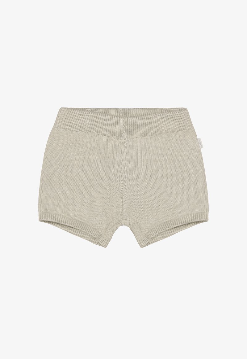 Shorts en maille beige clair, dotés d'une large ceinture côtelée, d'une texture douce et d'une construction sans coutures. Conviennent pour une tenue décontractée.