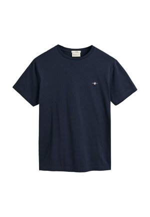 T-shirt in cotone blu navy con maniche corte, collo tondo e piccolo logo ricamato sul petto. Texture liscia, vestibilità classica, design minimale.