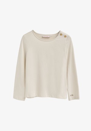 Maglia a maniche lunghe color crema realizzata in tessuto morbido con scollatura rotonda, caratterizzata da due bottoni decorativi su una spalla e logo ricamato sotto.