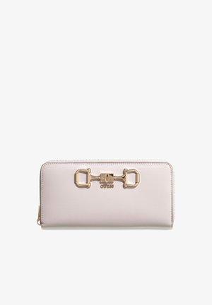Light pink zip-around wallet with gold decorative clasp and "GUESS" logo centered on front.