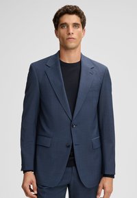 Marineblaue Sakkjacke aus strukturiertem Stoff mit Reverskragen, einem Knopfverschluss und zwei vorderen Taschen.