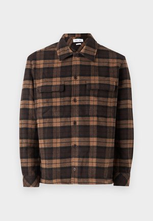 Brown and black plaid flannel shirt featuring a button-down front, two chest pockets, and a collar. Soft texture and relaxed fit.