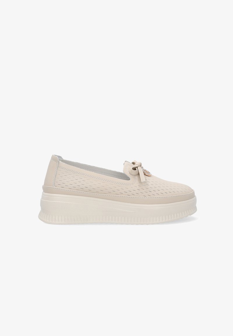 Beige durchbrochene Slipper mit dicker Sohle, versehen mit einem kleinen Schleifendetail und metallischen Akzenten. Glatte Textur, abgerundetes Design.