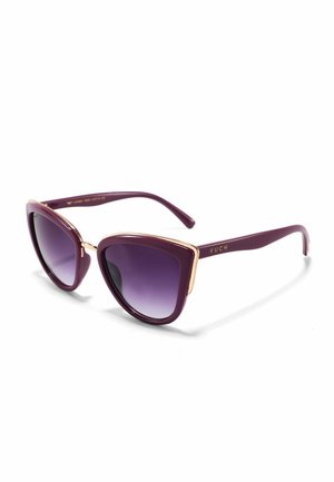 Purple cat-eye sunglasses with gradient lenses, gold metal accents on the frame, and a glossy finish. Brand name "VUCH" on the arm.