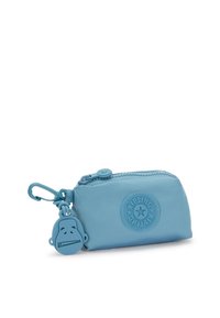 Small blue nylon pouch with a zip closure, featuring a textured logo and a plastic monkey keychain accent. Smooth surface and compact shape.