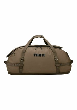Grand sac de sport marron Thule avec double poignée, sangles latérales et compartiment principal zippé.