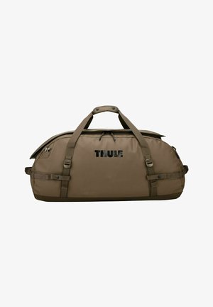Grand sac de sport marron Thule avec double poignée, sangles latérales et compartiment principal zippé.