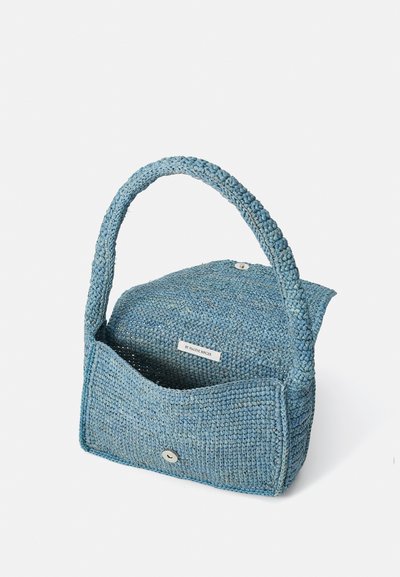 Blue woven handbag with a textured surface, a rounded top, and a single braided handle. Features a front pocket and a snap closure.