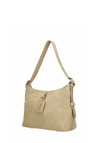 Borsa a tracolla in suede beige con tracolla regolabile, chiusura con cerniera e una targhetta appesa con la scritta "Wojas" su sfondo bianco.