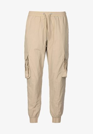 Beige cargo jogger pants with elastic waistband, drawstring closure, flap pockets on sides, and elastic cuffs at ankles.