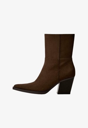 Brown suede ankle boot with a pointed toe and chunky heel, featuring minimalist design and smooth texture against a white background.