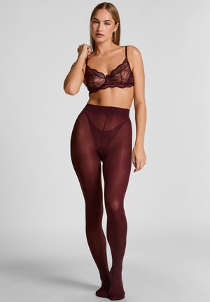 Burgundy lace bralette paired with sheer burgundy tights, featuring a high waistband and smooth texture, highlighting body contours.
