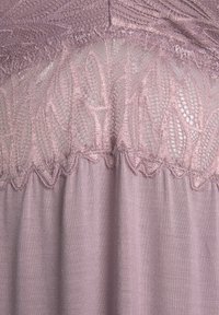 Dusty rose fabric with textured lace trim at the top. Soft, smooth texture with intricate leaf patterns in the lace detailing.