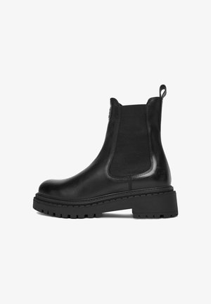 Black leather Chelsea boot with chunky rubber sole, elastic side panel, pull tab at heel, and low block heel.
