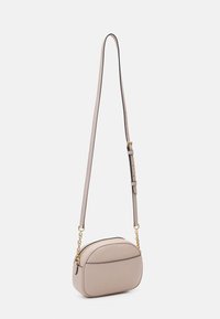 Bolso cruzado de color beige claro con forma redondeada, hecho de material texturizado, que cuenta con un acento de cadena dorada y una correa ajustable.