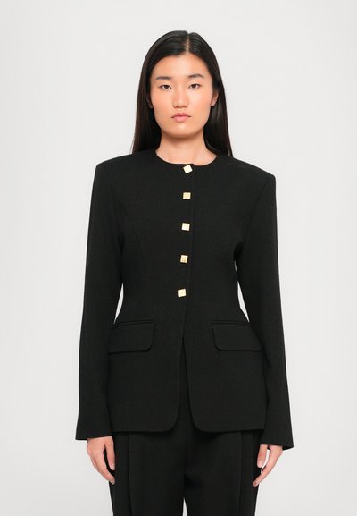 Black tailored blazer featuring a round neckline, front pockets, and five square gold-tone buttons for closure. Smooth texture and structured fit.