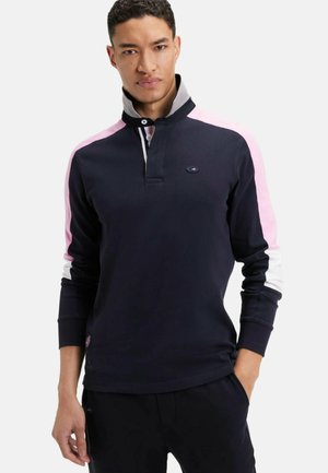 Polo à manches longues navy avec un col gris, des accents rose et blanc sur les épaules, et un col boutonné. Présente un détail de logo sur la poitrine.