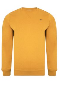 Sweatshirt jaune moutarde en tissu doux. Design classique à col rond avec poignets et ourlet côtelés. Petit logo sur le côté gauche de la poitrine.