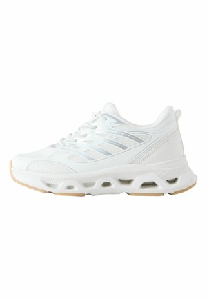 White athletic shoe with mesh upper featuring grey accent lines. Thick sole with cutouts and light brown rubber outsole. Rounded toe design.