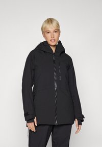 Black waterproof jacket featuring a high collar, adjustable cuffs, front zipper, and dual side pockets for utility and warmth.