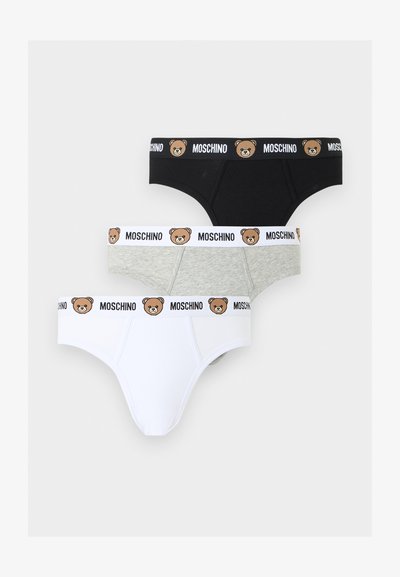 Τρία ανδρικά εσώρουχα σε μαύρο, γκρι και λευκό με ελαστικές ζώνες Moschino που φέρουν πρόσωπα αρκουδάκια.