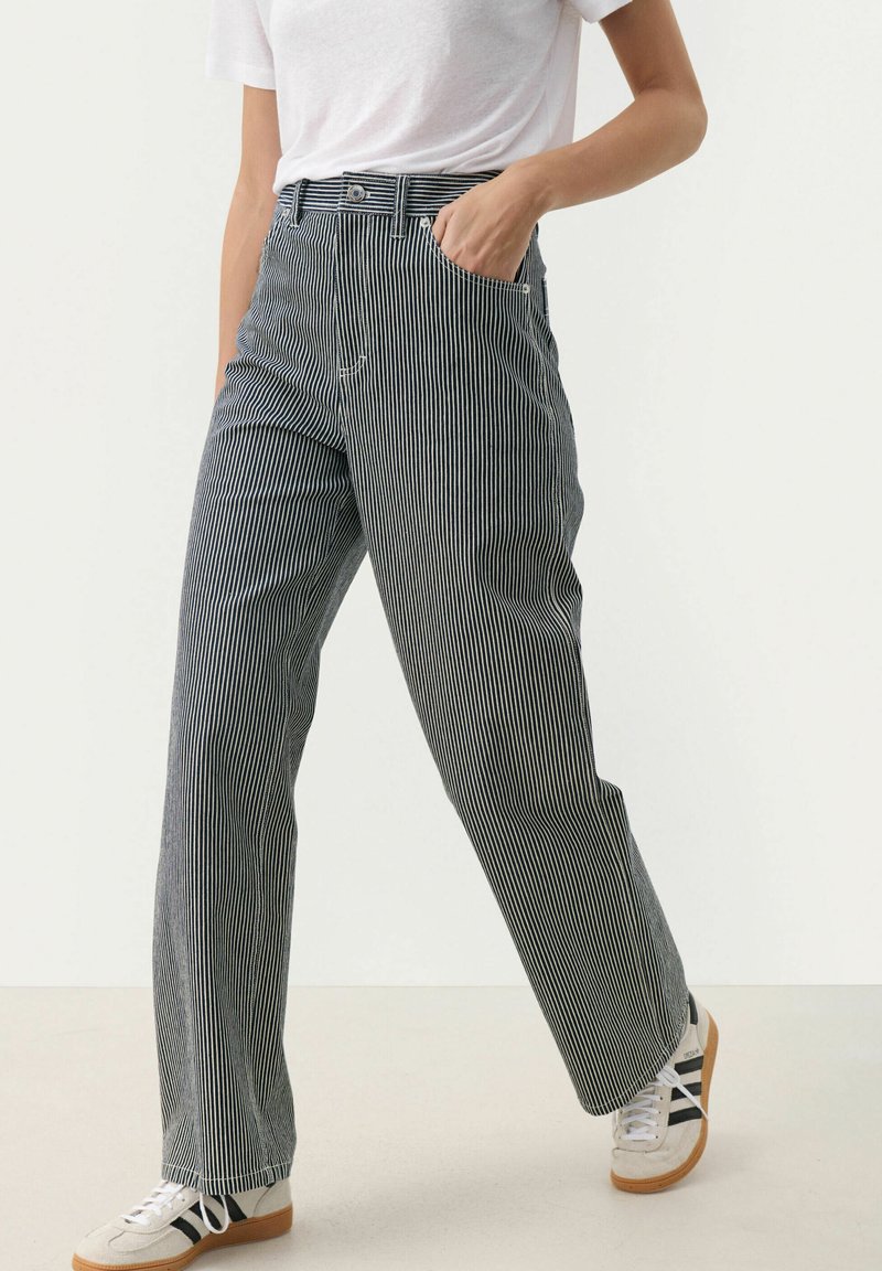 Gestreepte, losse broek in marineblauw en wit, gemaakt van zacht materiaal, met een hoge taille, voorzakken en subtiele stikdetails.