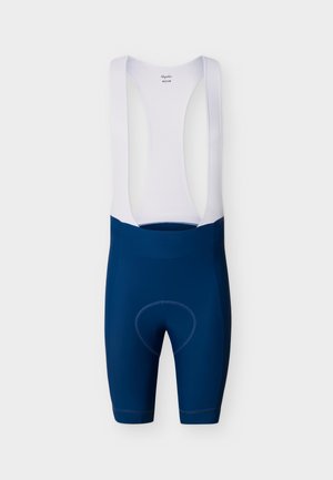 Navy cycling bib shorts with white mesh shoulder straps and padded chamois, size medium, displayed against a plain background.