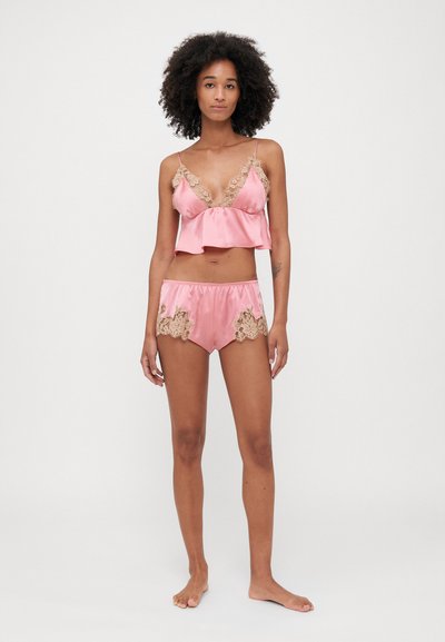 Roze satijnen top en short set, met kanten details, verstelbare spaghettibandjes en een relaxte pasvorm. Zachte textuur en lichtgewicht ontwerp.
