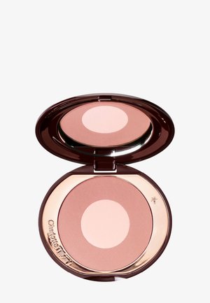 Compact rond avec un boîtier marron foncé. Contient un cercle rose pâle et un blush pêche. Texture lisse avec une finition brillante et des accents dorés.