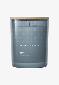 Frosted glass candle holder in soft gray with a wooden lid, featuring white geometric patterns and the text "Oy Island solitude."