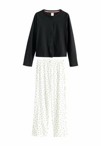 Black long-sleeve buttoned top paired with white wide-leg pants featuring a black polka dot pattern and elastic waistband.