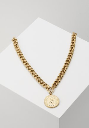 Gold chain necklace with thick links and round pendant featuring a female face and "GUESS" text around the edge.