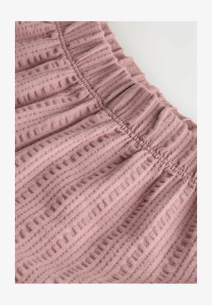 Mīksta rozā ribota auduma ar savilktu elastīgu jostasvietu un teksturētām vertikālām svītrām uz gluda fona.