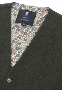 Dark green blazer with a notched collar, single button closure, and floral-patterned lining in blue and peach tones. Tag visible inside.