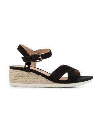 Sandali con zeppa in suede nero caratterizzati da un design incrociato, cinturino alla caviglia regolabile con fibbia e base piattaforma avvolta in juta.