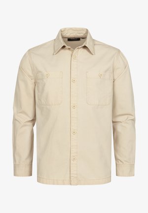 Krémszínű, hosszú ujjú, puha pamutból készült ing, gombos elülső résszel, két mellzsebbel és klasszikus galléros kialakítással.