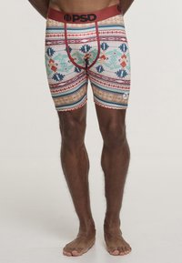 Boxer aderenti da uomo in un colore chiaro con un motivo tribale in teal, rosso e arancione. Presenta una cintura elastica nera con il logo "PSD".