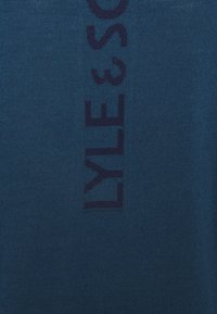 Navy blue knit sweater featuring a vertical knitted logo "LYLE & SCOTT" in dark blue. Soft texture with a regular fit and crew neckline.