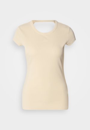 Light beige ribbed T-shirt with short sleeves, featuring a round neckline and a small embossed logo on the chest. Soft fabric texture.