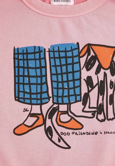 Illustration d'une jambe portant un pantalon à carreaux bleus et des chaussures orange à côté d'un chien tacheté aux oreilles orange, avec le texte « L'amitié canine est pour toujours. »